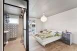 This modern apartment features a stylish bedroom with a minimalist design.