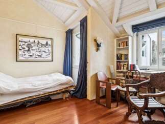 Discover the charm of this cozy bedroom, featuring a unique sloped ceiling and exposed beams that add character.