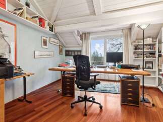 This stunning home office boasts a bright and airy atmosphere, perfect for productivity.