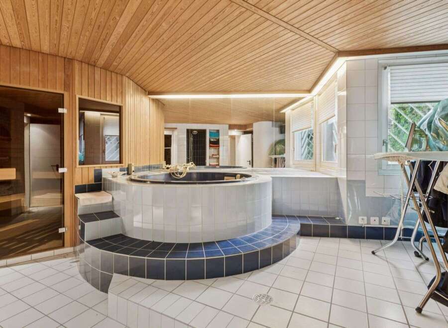This luxurious bathroom boasts a unique design with a built-in jacuzzi and sauna.