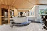 This luxurious bathroom boasts a unique design with a built-in jacuzzi and sauna.