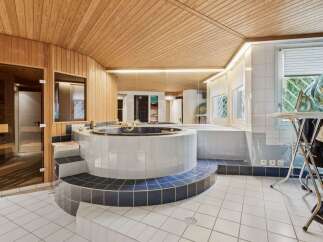 This luxurious bathroom boasts a unique design with a built-in jacuzzi and sauna.