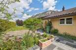 Discover the charm of this beautiful property, featuring a well-maintained garden and a stunning mountain backdrop.