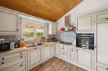 This stunning kitchen boasts a classic design with a modern touch, perfect for culinary enthusiasts.