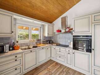 This stunning kitchen boasts a classic design with a modern touch, perfect for culinary enthusiasts.
