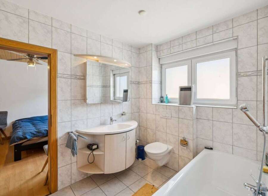 This bright and airy bathroom features a modern design with clean lines and a neutral color palette.