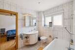 This bright and airy bathroom features a modern design with clean lines and a neutral color palette.