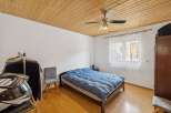 This cozy bedroom features a comfortable bed with a blue comforter, perfect for a relaxing night's sleep.