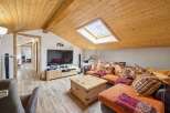 Discover the charm of this stunning property, featuring a cozy living room with a unique sloped ceiling and a skylight that floods the space with natural light.