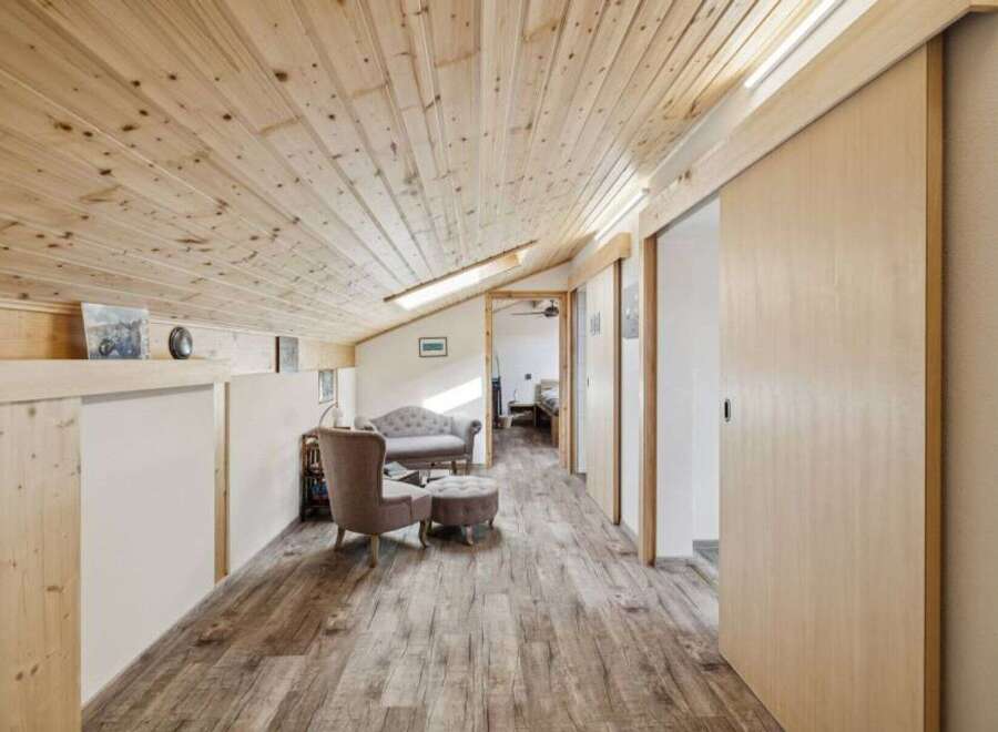 This stunning property features a beautifully designed interior with a focus on natural materials.