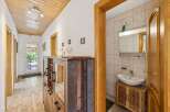 Step into this inviting hallway, featuring a stylish wooden ceiling and elegant flooring.