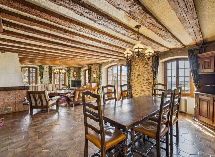 Step into a world of rustic elegance with this stunning property, featuring exposed wooden beams and stone walls that exude timeless charm.