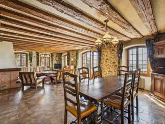 Step into a world of rustic elegance with this stunning property, featuring exposed wooden beams and stone walls that exude timeless charm.