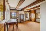 Step into this charming room, featuring exposed wooden beams that add a touch of rustic elegance.
