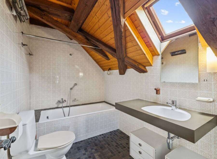 Discover the charm of this unique bathroom, featuring a skylight that floods the space with natural light.