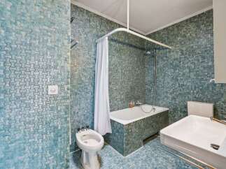 Step into this unique bathroom featuring stunning blue mosaic tiles that create a captivating visual appeal.