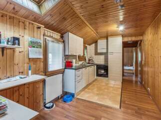Step into this charming kitchen with its warm wooden accents and inviting atmosphere.