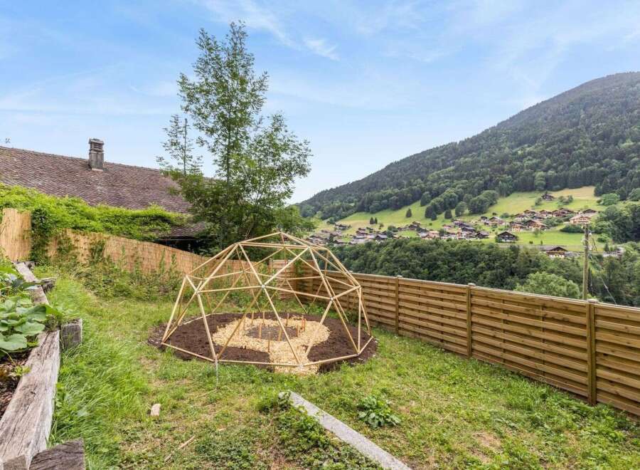 Discover a charming property with a unique geodesic dome structure, perfect for a garden or outdoor retreat.