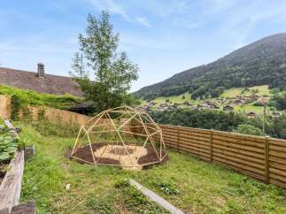 Discover a charming property with a unique geodesic dome structure, perfect for a garden or outdoor retreat.