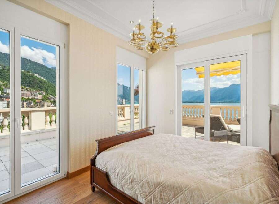 Experience luxury living in this stunning bedroom with breathtaking views.