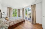 Experience luxury in this stunning bedroom featuring a spacious bed and elegant curtains.