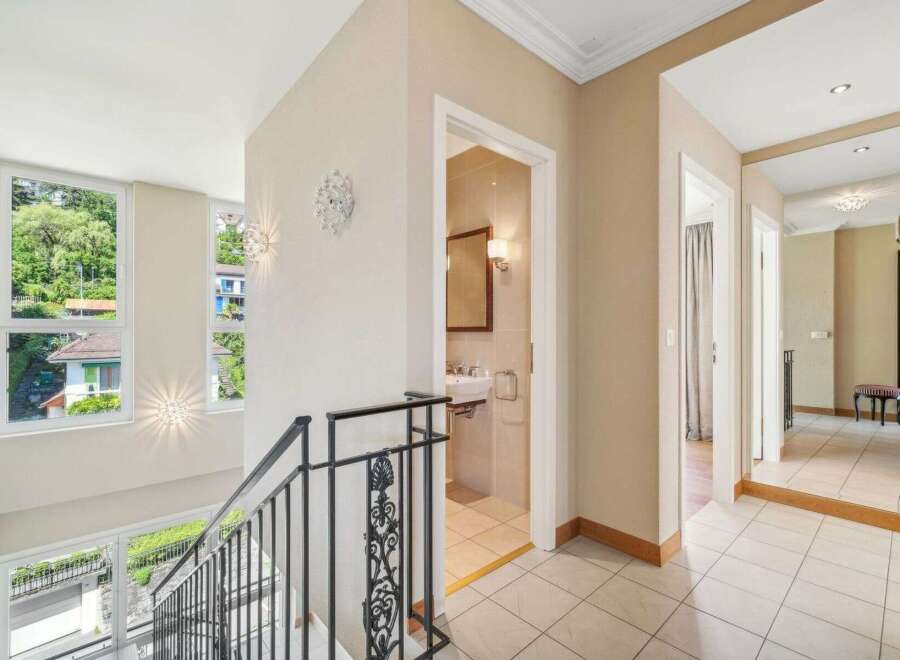 Discover this stunning property featuring a bright and airy hallway with elegant design elements.