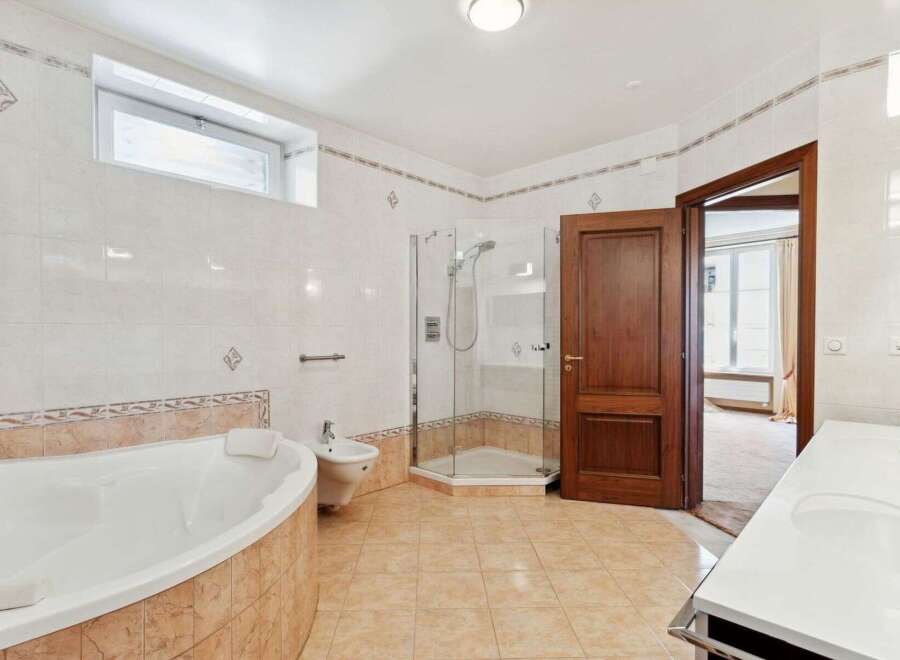 This luxurious bathroom boasts a spacious layout with a modern design.