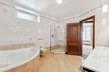 This luxurious bathroom boasts a spacious layout with a modern design.