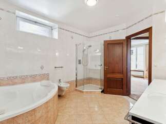 This luxurious bathroom boasts a spacious layout with a modern design.