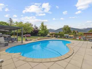 Enjoy the ultimate outdoor living experience with this stunning property! Featuring a beautiful pool, perfect for those hot summer days, and a spacious patio area ideal for entertaining.