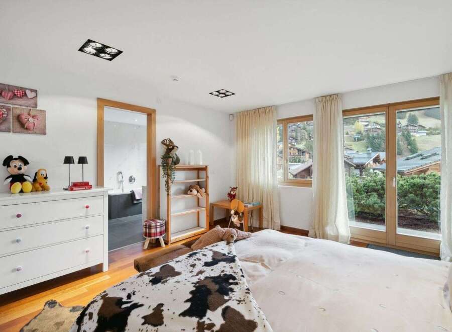 This charming bedroom offers a cozy retreat with stunning views.