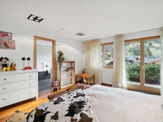 This charming bedroom offers a cozy retreat with stunning views.
