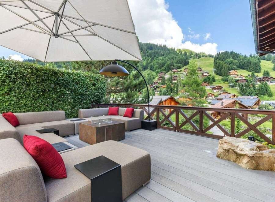 Experience luxury living with this stunning property featuring a spacious outdoor deck and breathtaking mountain views.