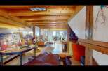 Step into this unique and inviting living space, showcasing exposed wooden beams and a cozy atmosphere.