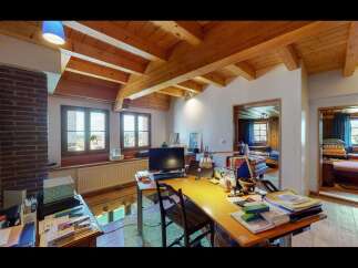 This charming property boasts a unique interior design with exposed wooden beams and a cozy atmosphere.