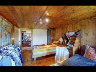 Step into this charming bedroom featuring warm wooden accents and a cozy atmosphere.