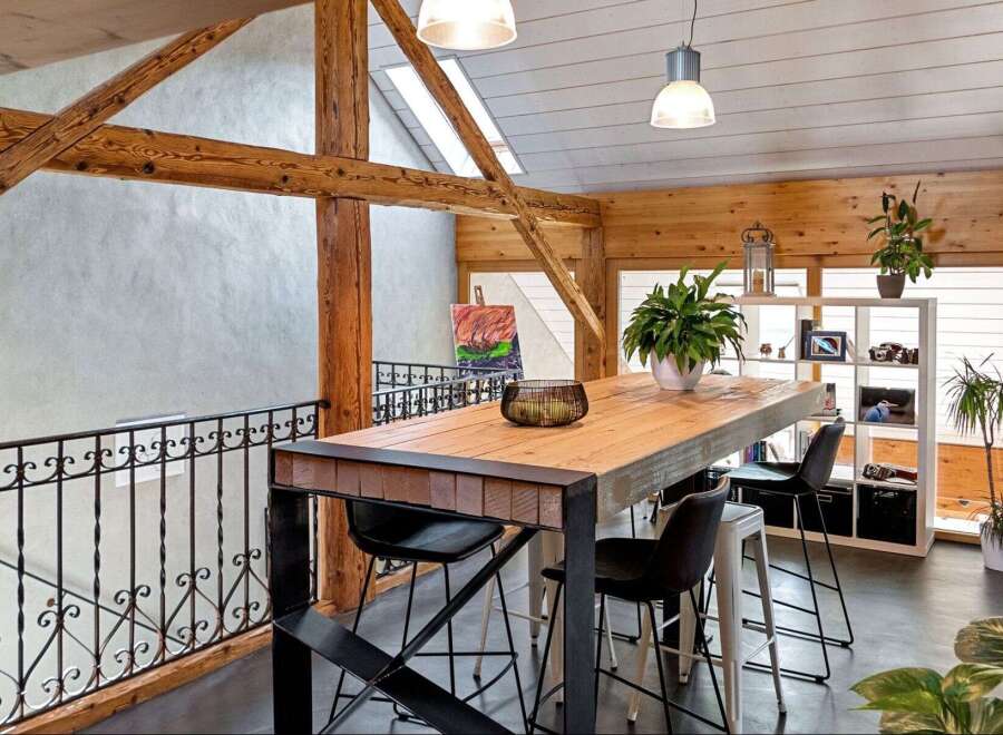 This stunning property boasts a unique architectural design with exposed wooden beams and a modern loft-style layout.