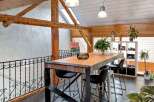 This stunning property boasts a unique architectural design with exposed wooden beams and a modern loft-style layout.