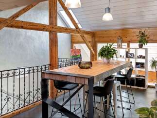 This stunning property boasts a unique architectural design with exposed wooden beams and a modern loft-style layout.
