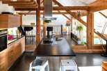 This stunning kitchen boasts a modern design with a touch of rustic charm, perfect for those seeking a unique living space.