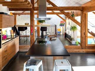 This stunning kitchen boasts a modern design with a touch of rustic charm, perfect for those seeking a unique living space.