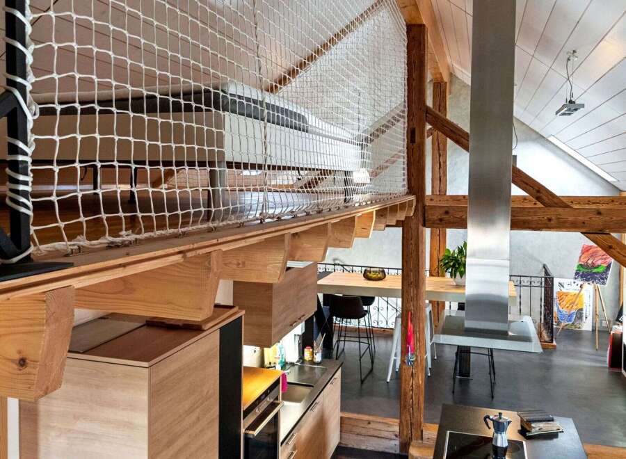 This stunning property boasts a unique loft design with exposed wooden beams and a modern kitchen.