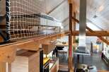 This stunning property boasts a unique loft design with exposed wooden beams and a modern kitchen.