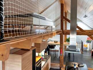 This stunning property boasts a unique loft design with exposed wooden beams and a modern kitchen.
