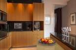 This modern kitchen boasts sleek wooden cabinetry, offering ample storage and a warm aesthetic.
