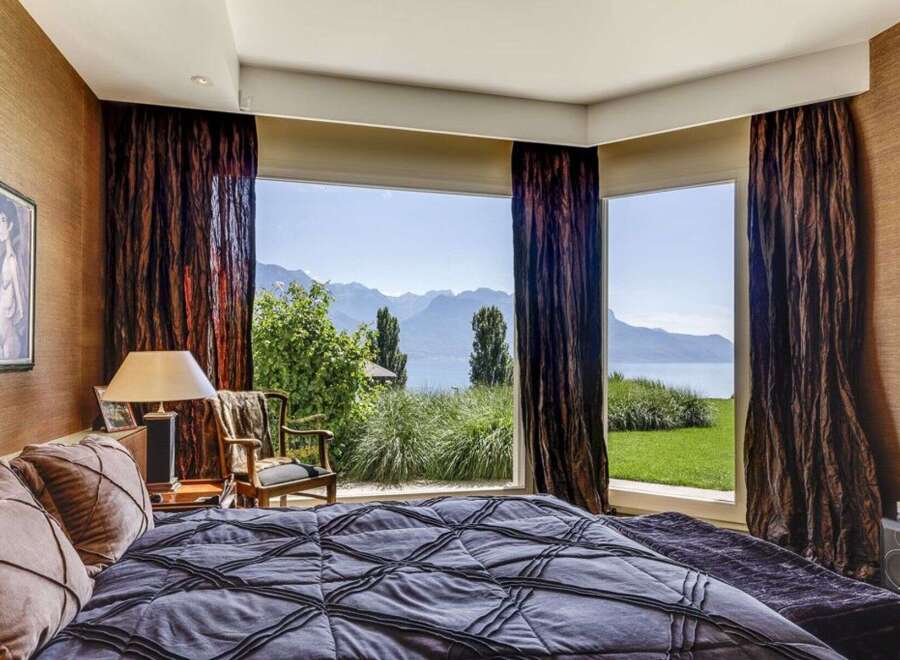 Experience luxury living in this stunning bedroom with breathtaking views.