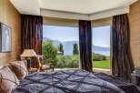 Experience luxury living in this stunning bedroom with breathtaking views.