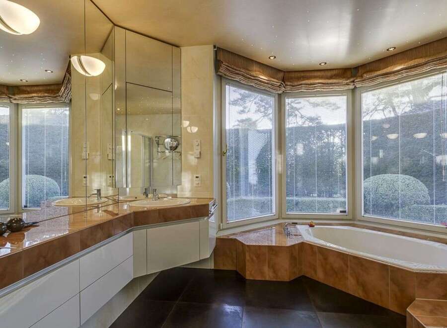 Step into luxury with this stunning bathroom featuring a modern design and high-end finishes.