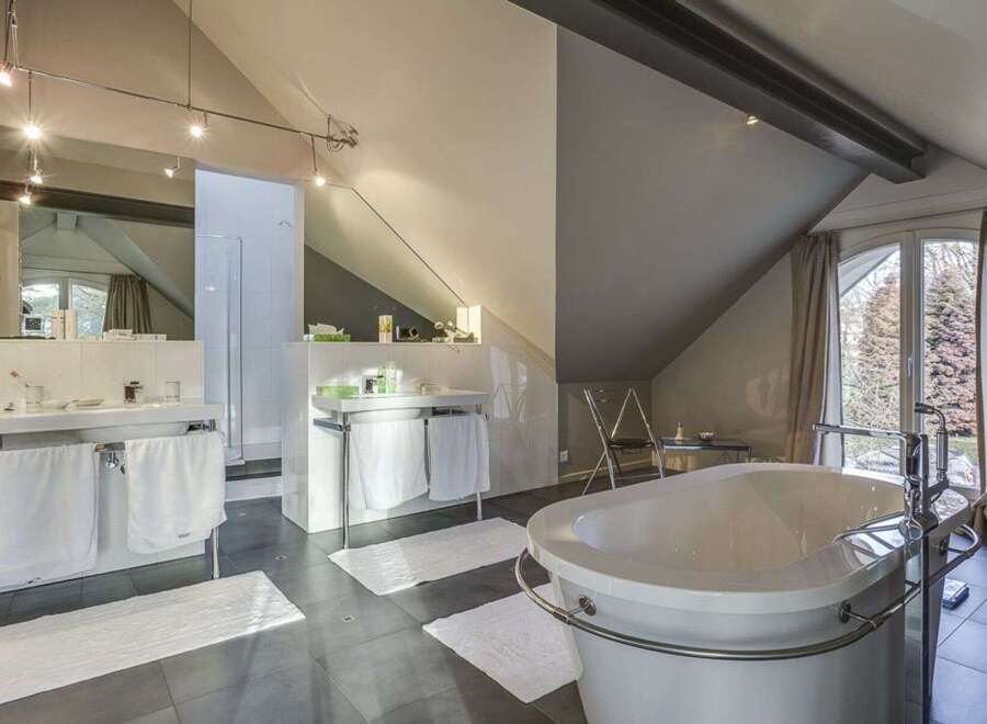 This luxurious bathroom boasts a modern design with a freestanding bathtub, perfect for relaxation.