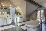 This luxurious bathroom boasts a modern design with a freestanding bathtub, perfect for relaxation.